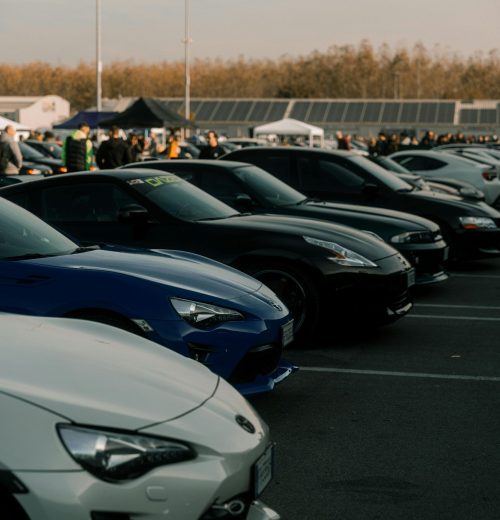 RCA Lineup of sports cars at an outdoor event in Cremona, Italy, showcasing automotive diversity.