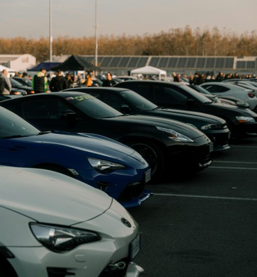 Projects Lineup of sports cars at an outdoor event in Cremona, Italy, showcasing automotive diversity.