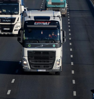 CMR/Transport Marfă Heavy duty trucks driving on a highway, showcasing transportation and logistics.